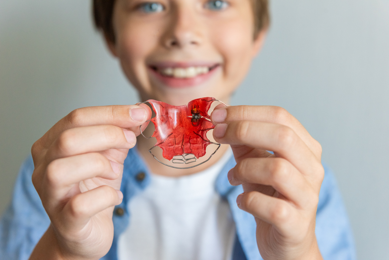 Child boy with Dental plate. Expansion of the jaw in a child.