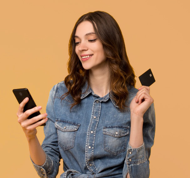 Woman seeing Squires Orthodontics’ flexible payment options on her phone and holding her credit card